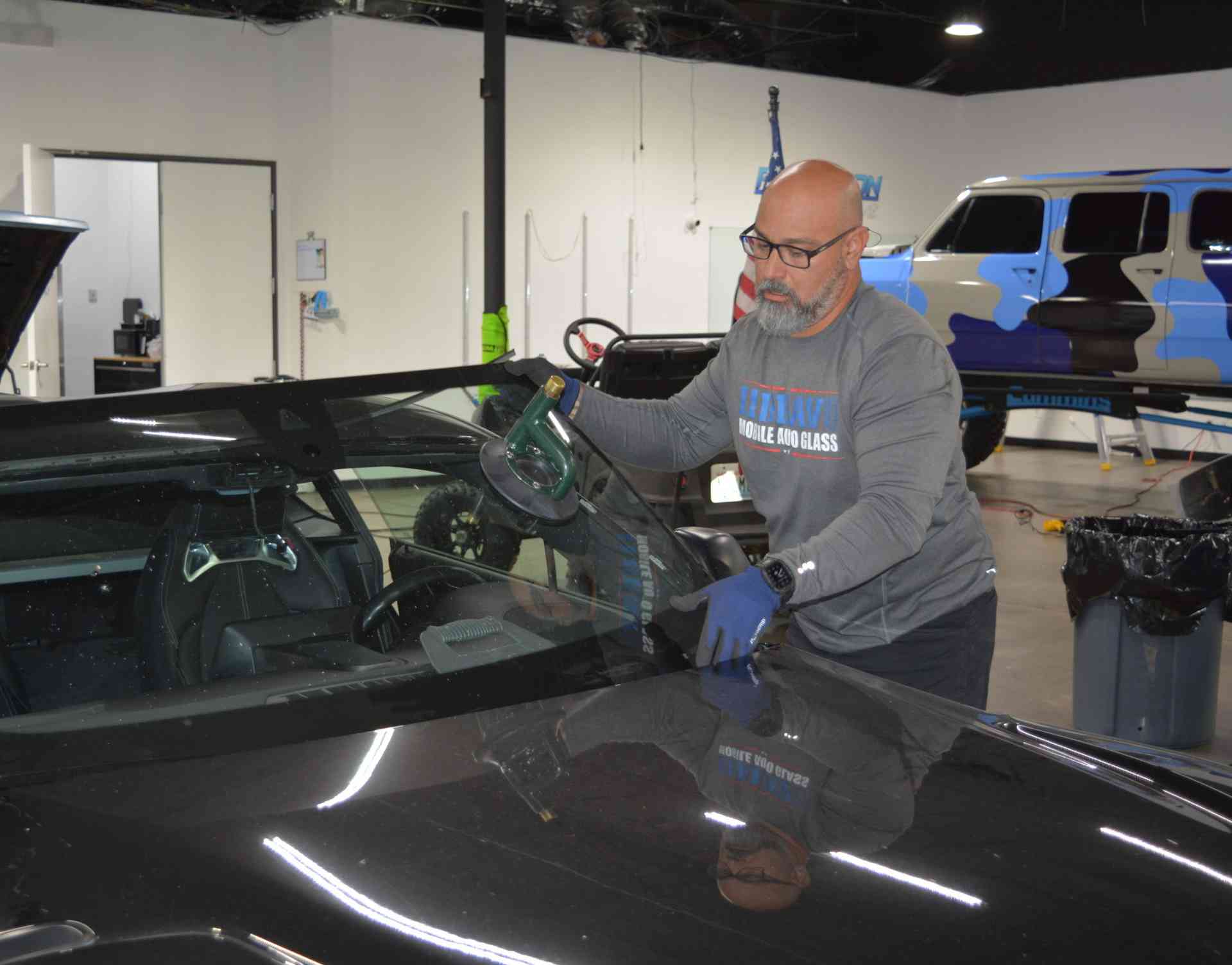 Auto glass technician installing a windshield in Surprise, AZ