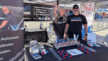 Mobile auto glass booth with giveaways and promotional displays at an event in Surprise, AZ